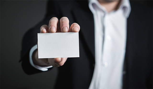 man holding blank business card